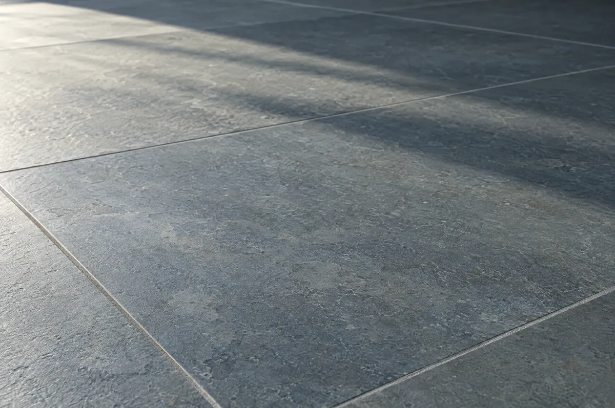 Close-up of a honed blue-grey Kota stone floor with straight grout lines